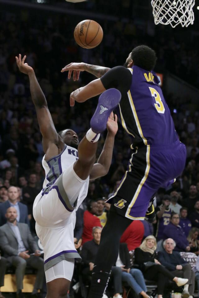 Los Angeles Lakers forward Anthony Davis, right, blocks a shot by Sacramento Kings forward Harrison Barnes, left, in the last second of an NBA basketball game in Los Angeles, Friday, Nov. 15, 2019. The Lakers won 99-97. (AP Photo/Alex Gallardo)