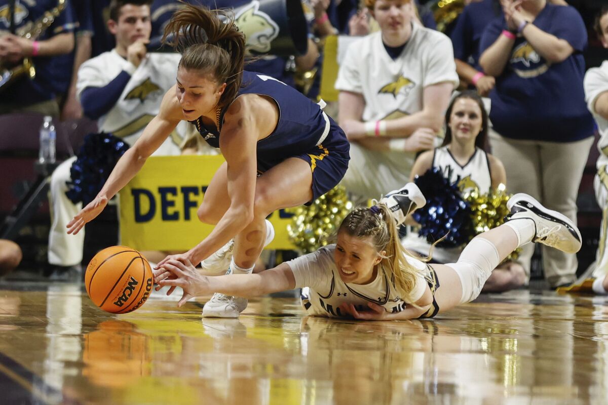 Montana State guard Madison Jackson, left, and Northern Arizona guard Emily Rodabaugh both go for the ball during an NCAA college basketball game in the championship of the Big Sky Conference in Boise, Idaho, Friday, March 11, 2022. (AP Photo/Otto Kitsinger)
