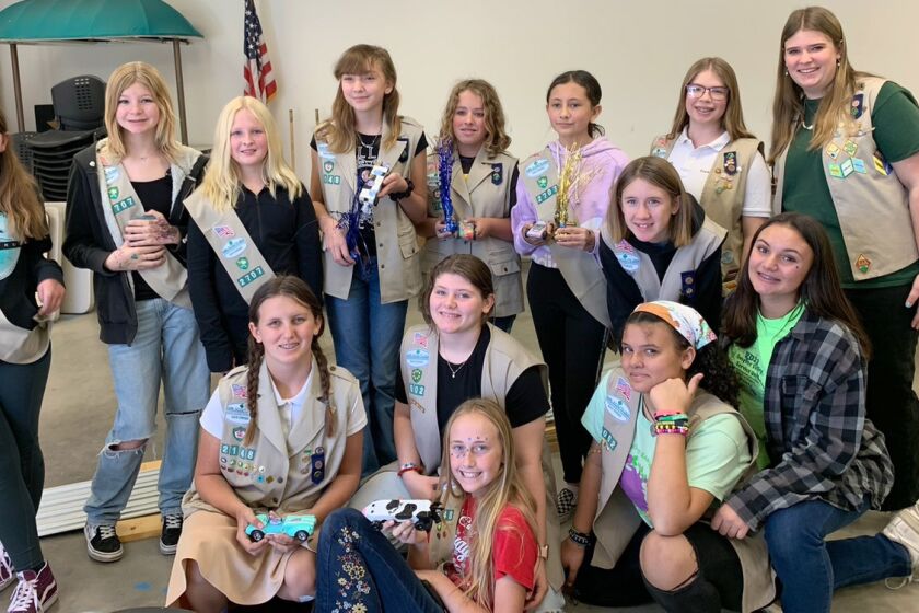 Cadette, ambassador and senior Girl Scout Troops display their handmade pinewood derby cars.