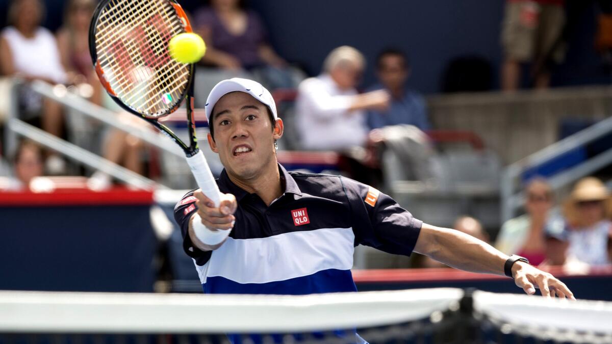 Kei Nishikori returns a shot against Pablo Andujar during their match at the Rogers Cup.