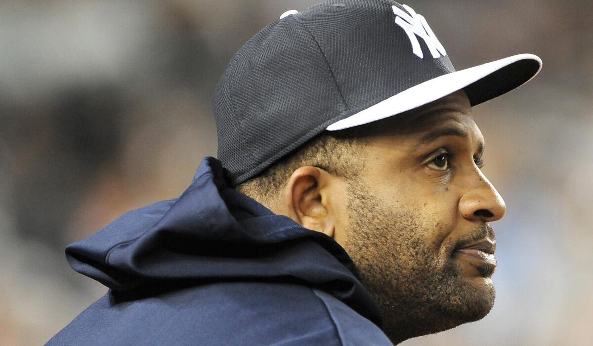 Yankees starting pitcher CC Sabathia watches an interleague baseball game against the New York Mets from the dugout earlier this season.