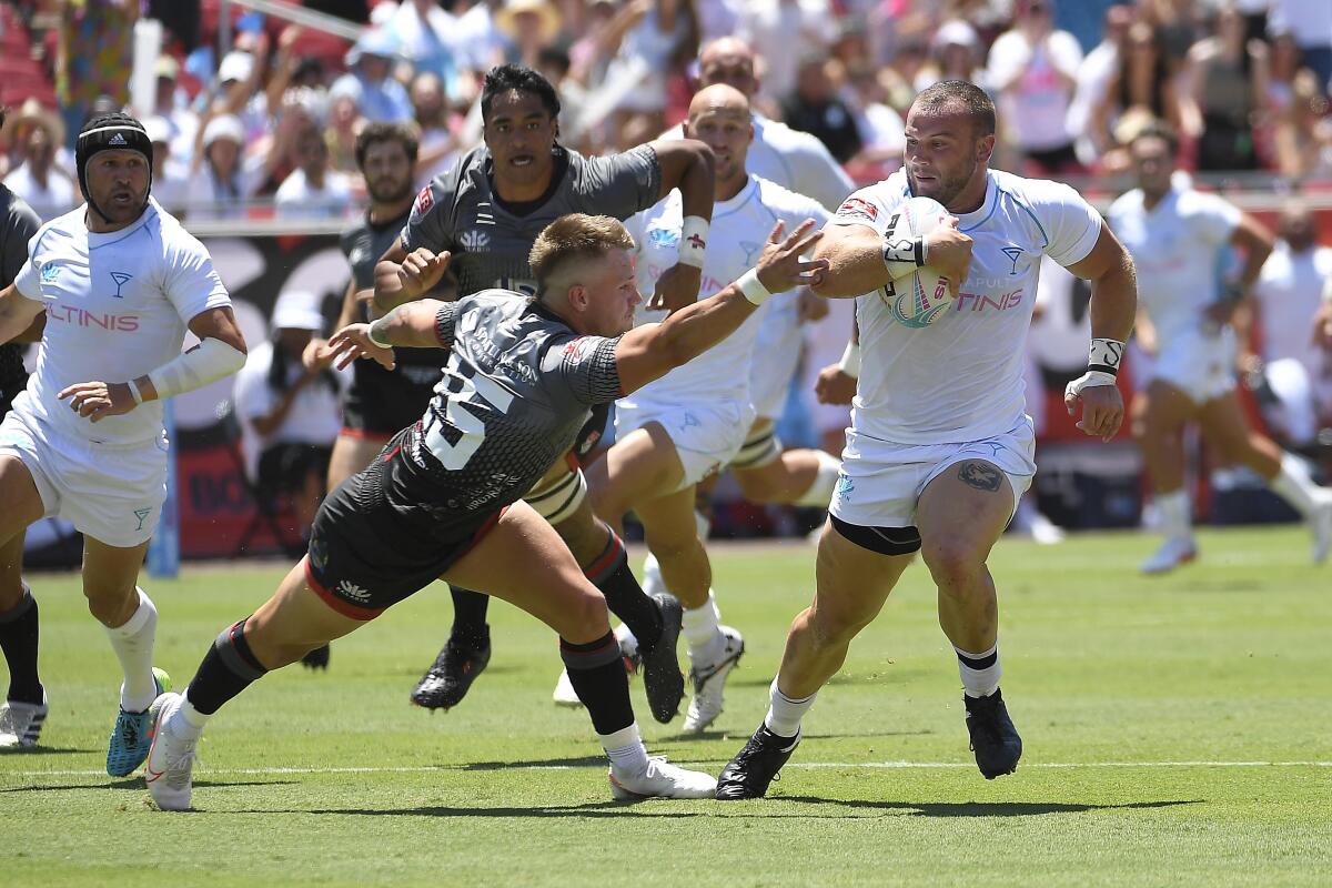 The Giltinis' Johnny Ryberg runs for a try against Rugby ATL.