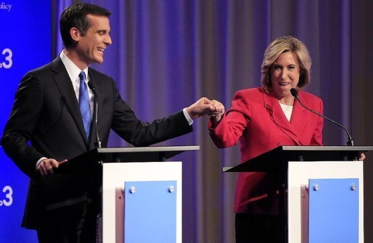 Los Angeles mayoral candidates Eric Garcetti and Wendy Greuel exchange a fist-bump before a debate this week.