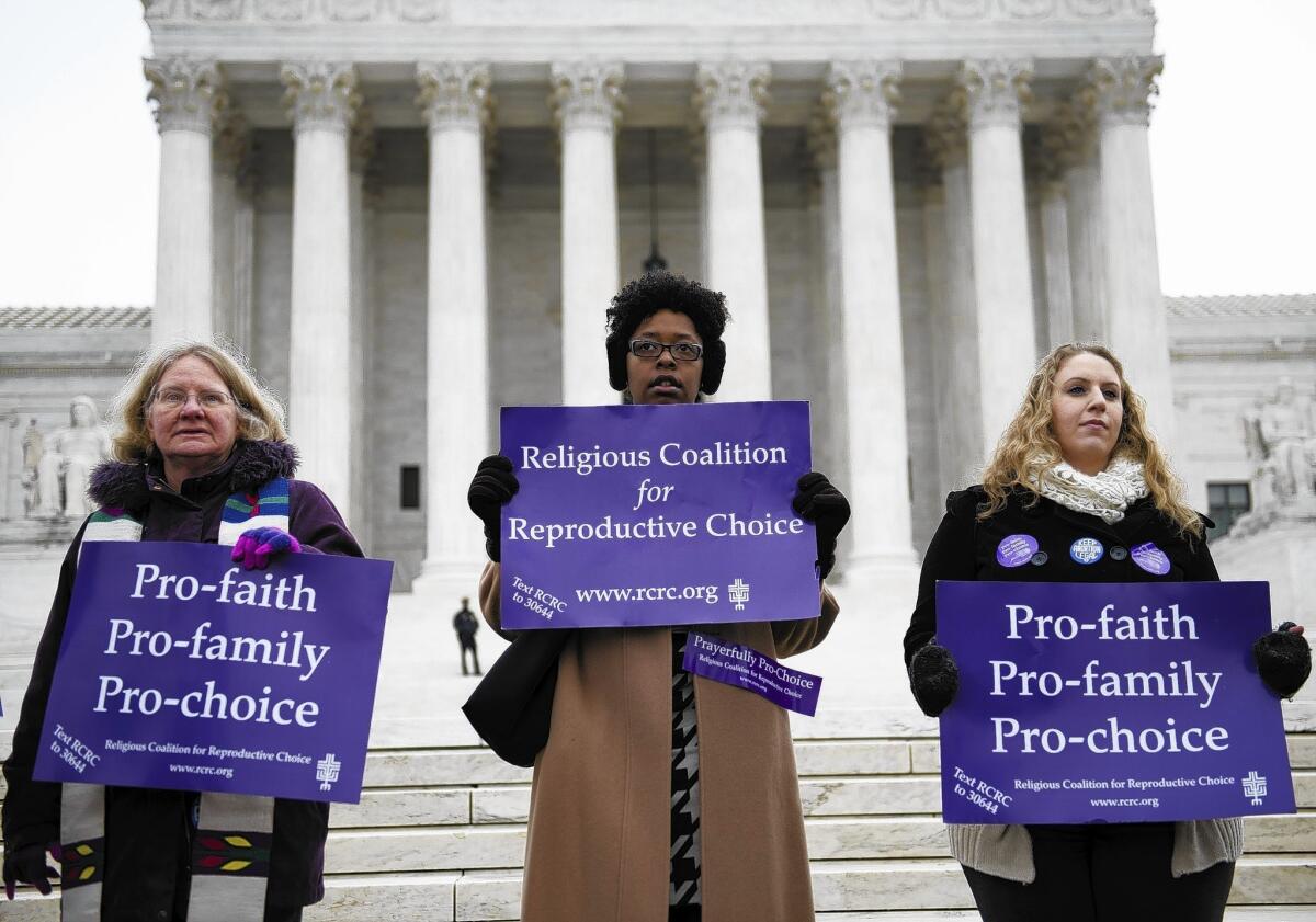 Supporters of the Massachusetts law establishing a 35-foot buffer zone at abortion clinics demonstrate outside the Supreme Court in Washington.