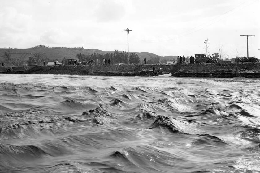 The San Diego River raging in Old Town during a flood in January 1916. (San Diego History Center). ONE TIME USE