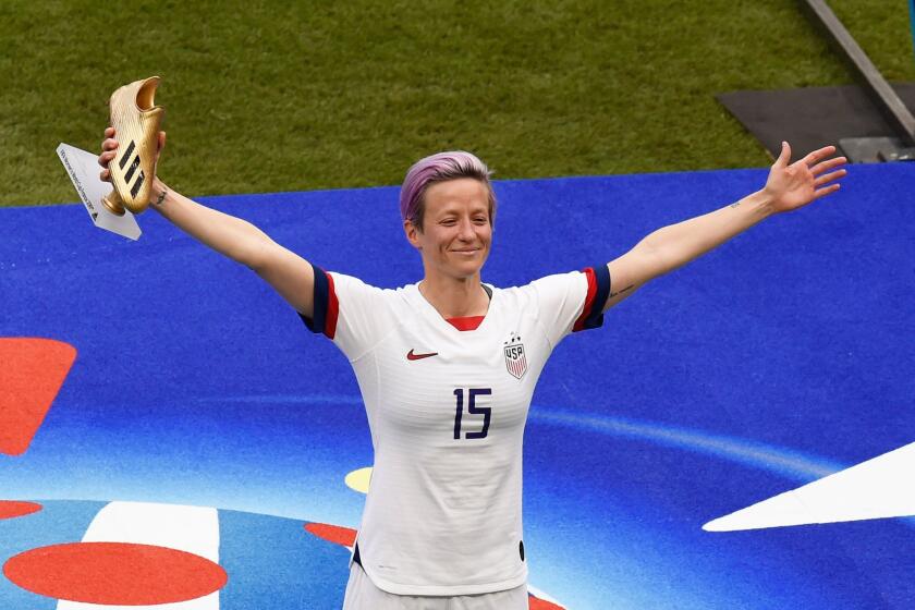 American forward Megan Rapinoe poses with the Golden Boot after scoring the most goals in the Women's World Cup.