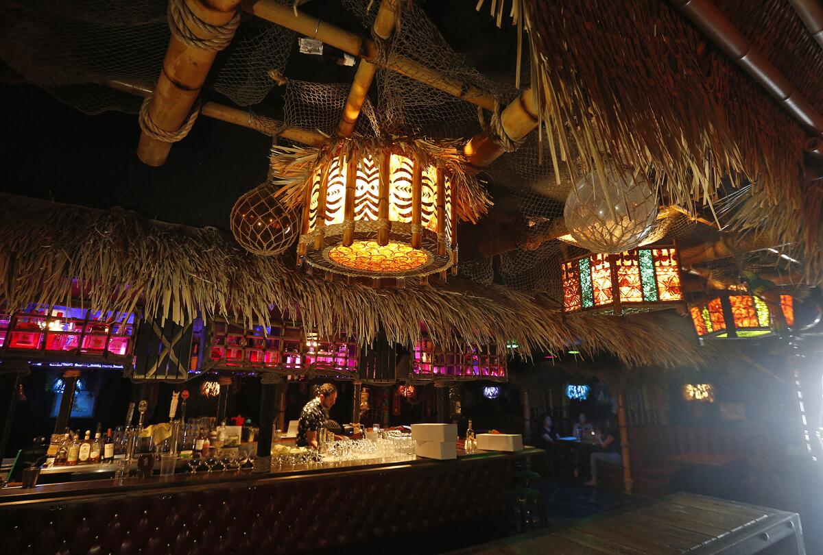 The central bar at the new Stowaway Tiki location in Tustin is adorned with South Pacific decor.