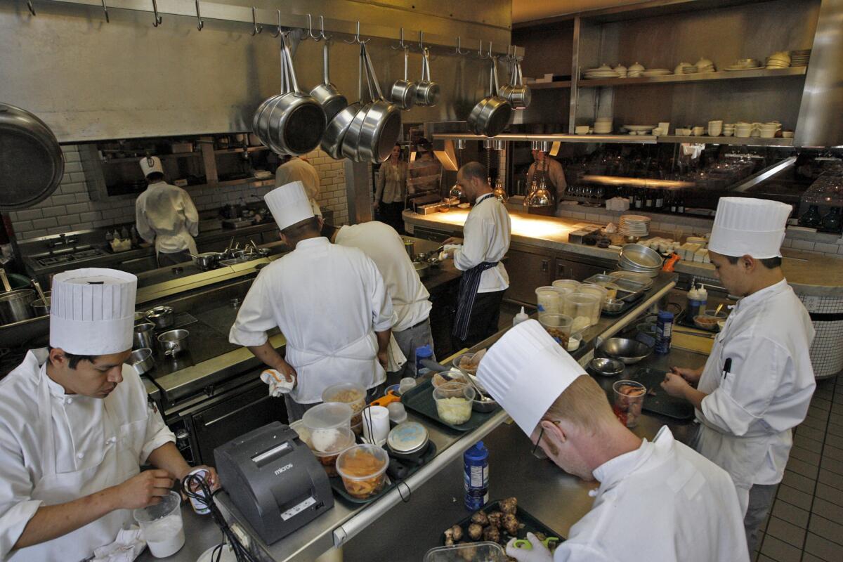 Staffers work in the spacious kitchen at Hatfield's in Los Angeles in 2010. The fine dining restaurant is closing after eight years.