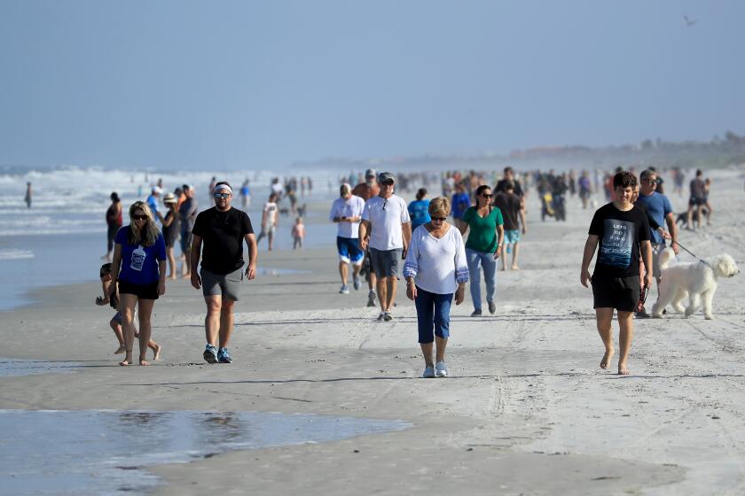 JACKSONVILLE BEACH, FLORIDA - APRIL 17: People are seen at the beach on April 17, 2020 in Jacksonville Beach, Florida. Jacksonville Mayor Lenny Curry announced Thursday that Duval County's beaches would open at 5 p.m. but only for restricted hours and can only be used for swimming, running, surfing, walking, biking, fishing, and taking care of pets. (Photo by Sam Greenwood/Getty Images)