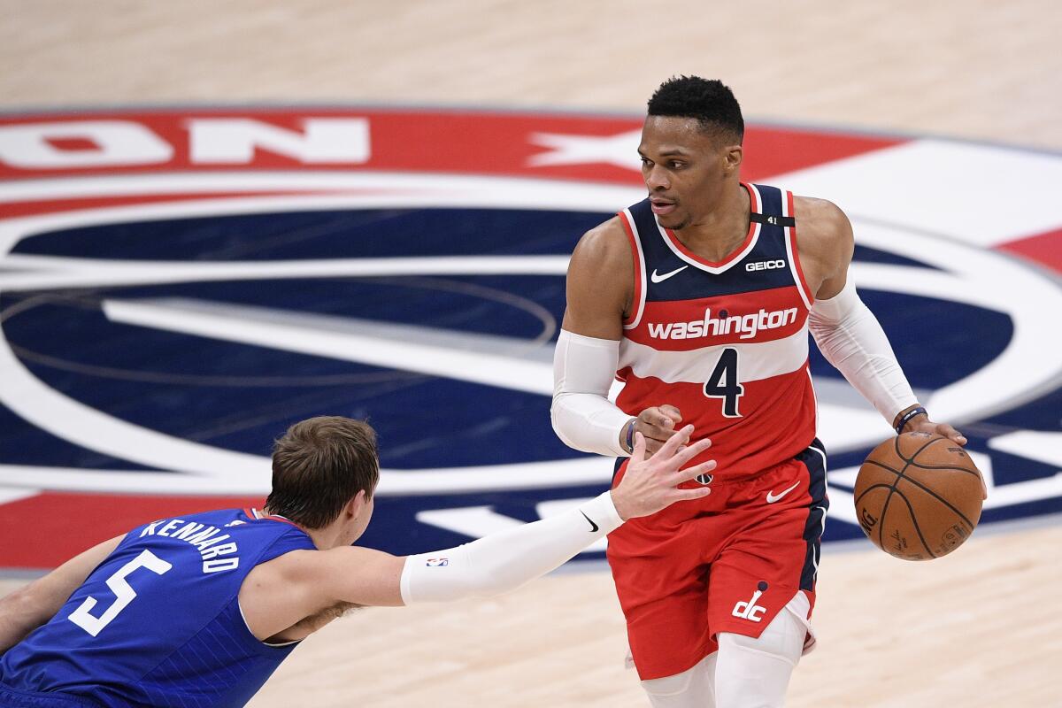 Washington Wizards guard Russell Westbrook (4) dribbles against Los Angeles Clippers guard Luke Kennard (5) during the first half of an NBA basketball game, Thursday, March 4, 2021, in Washington. (AP Photo/Nick Wass)