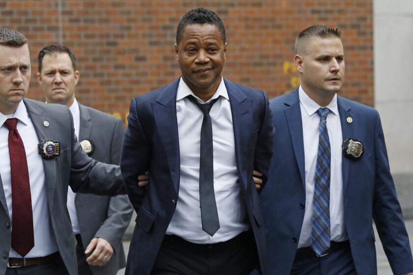 Actor Cuba Gooding Jr., center, is lead by police officers from the New York Police Department's special victims division, Thursday, June 13, 2019, in New York. Gooding Jr., 51, was arrested Thursday after turning himself in, was charged with forcible touching after a woman accused the actor of groping her at a New York City night spot. (AP Photo/Mark Lennihan)