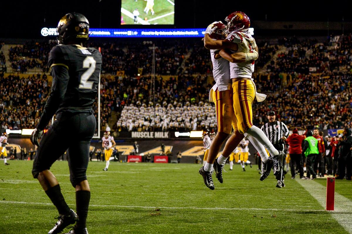 USC wide receiver Tyler Vaughns, left, and quarterback Kedon Slovis celebrate a touchdown during the fourth quarter of the Trojans' win over Colorado on Friday.