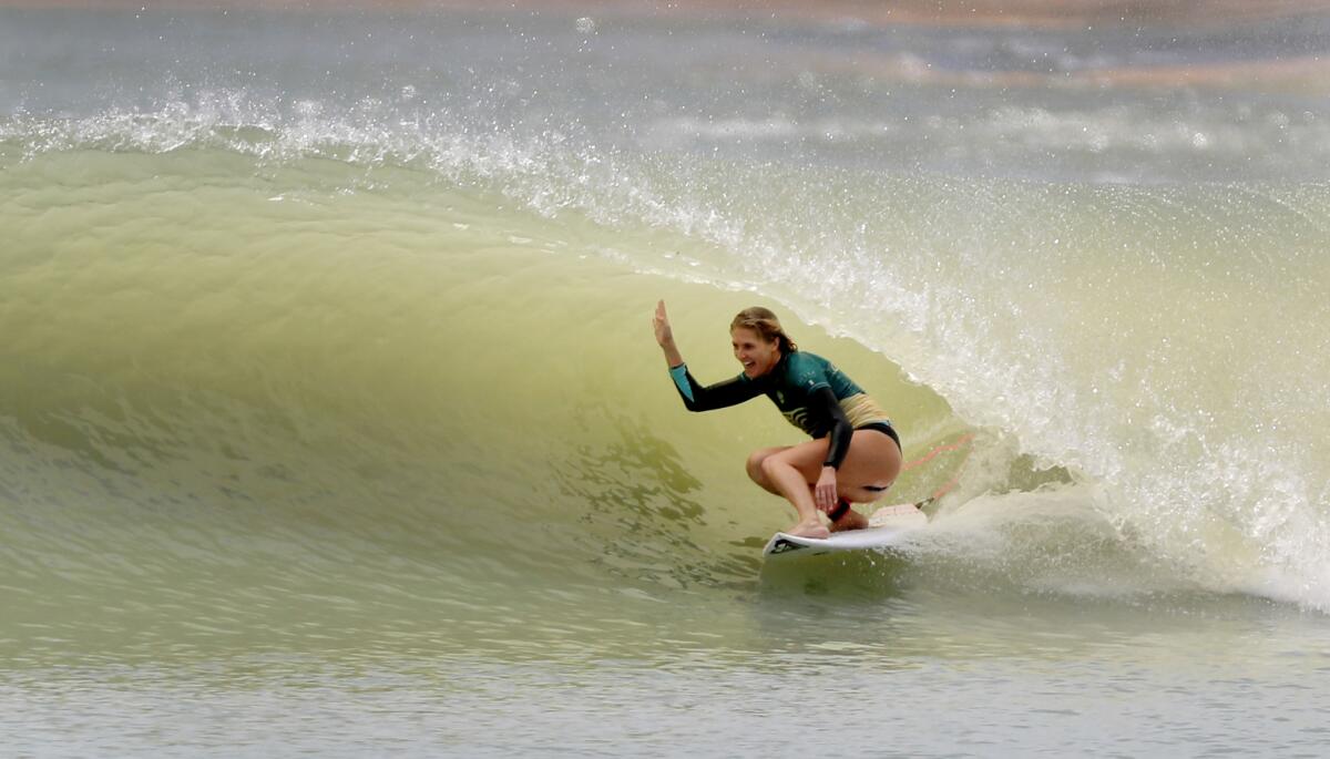 Stephanie Gilmore, of Australia, celebrates her long tube ride.