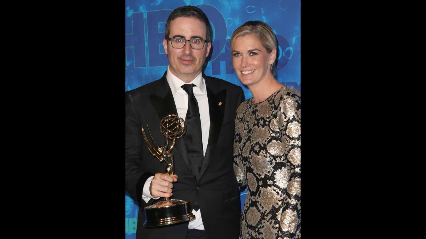 Comedian John Oliver, left, and Kate Norley attend HBO's Emmys after-party.
