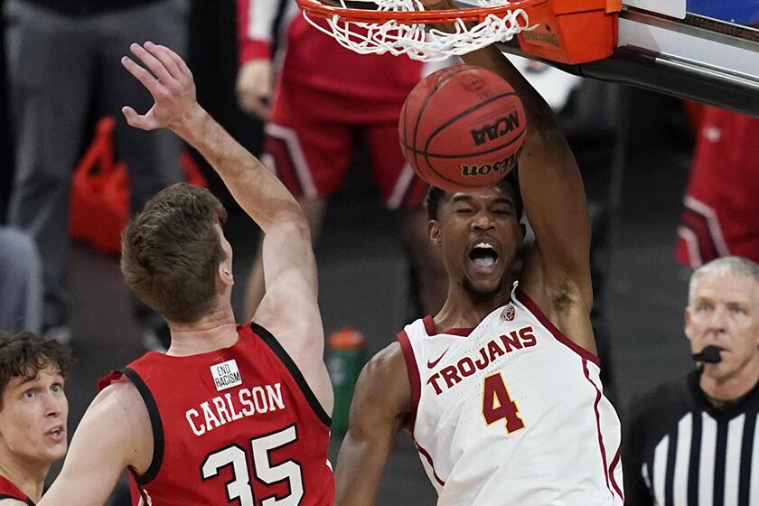USC’s Evan Mobley dunks against Utah’s Branden Carlson during the first half of the quarterfinals of the Pac-12 tournament.