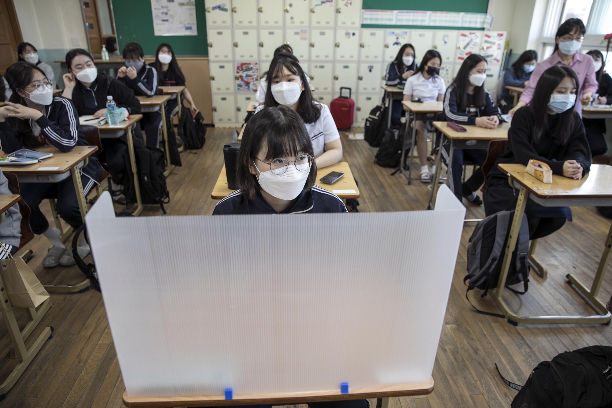 Students at Gyungbuk Girls' High School await the first bell on their first day back after school closures in Daegu, South Korea, due to the COVID-19 pandemic. High school seniors were the first to resume classes in the country.