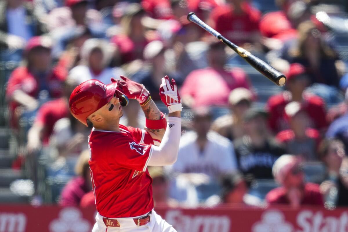 The Angels' Zach Neto tosses his bat as he flies out to center field during the seventh inning Sunday.