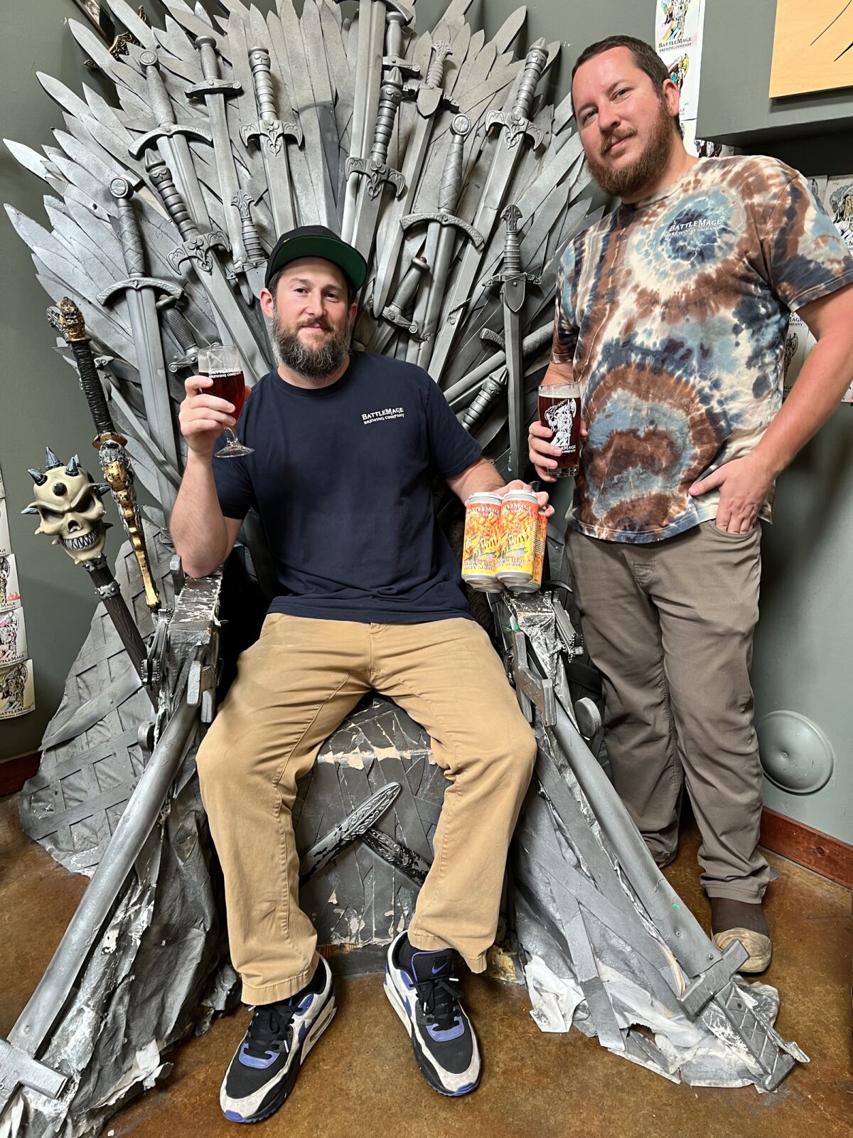BattleMage Brewing co-founders Chris Barry, seated, and Ryan Sather, with their Summon Ifrit Hoppy Amber beer.