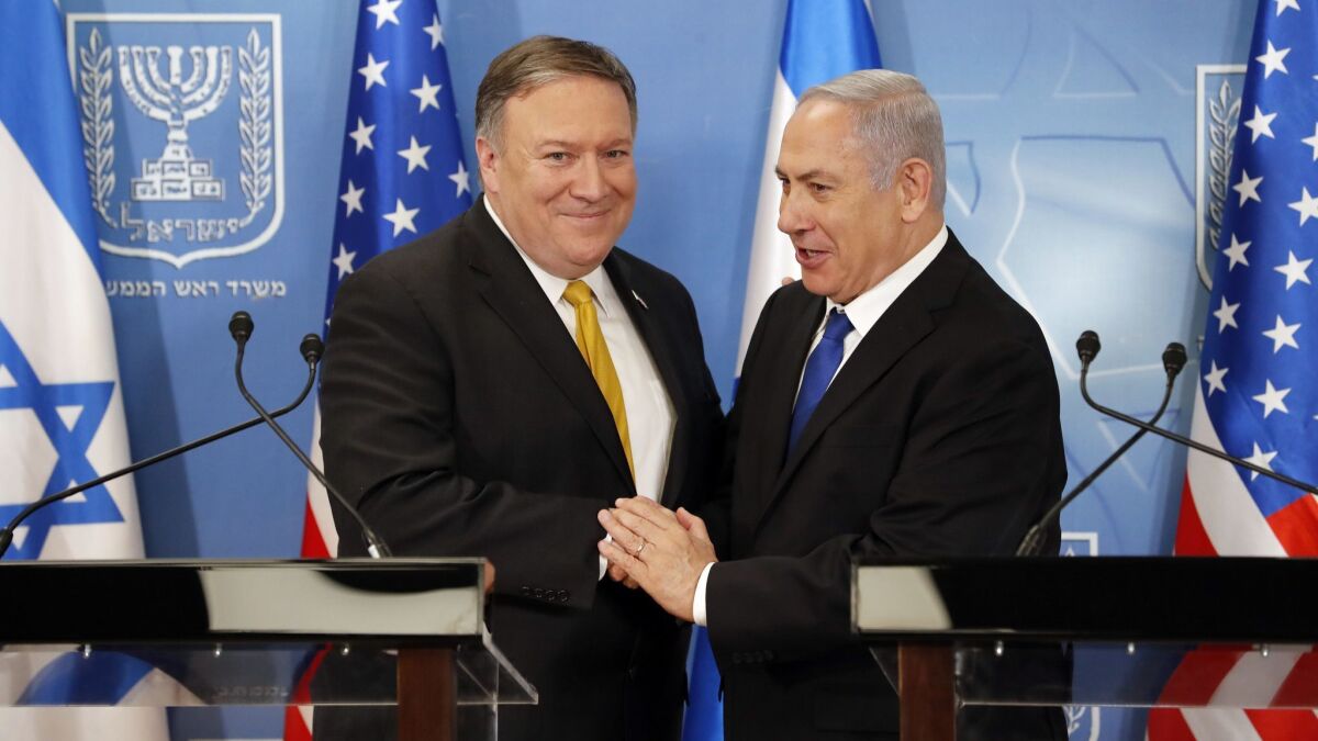 Secretary of State Mike Pompeo. left. is greeted by Israeli Prime Minister Benjamin Netanyahu ahead of a press conference at the Ministry of Defense in Tel Aviv on Sunday.
