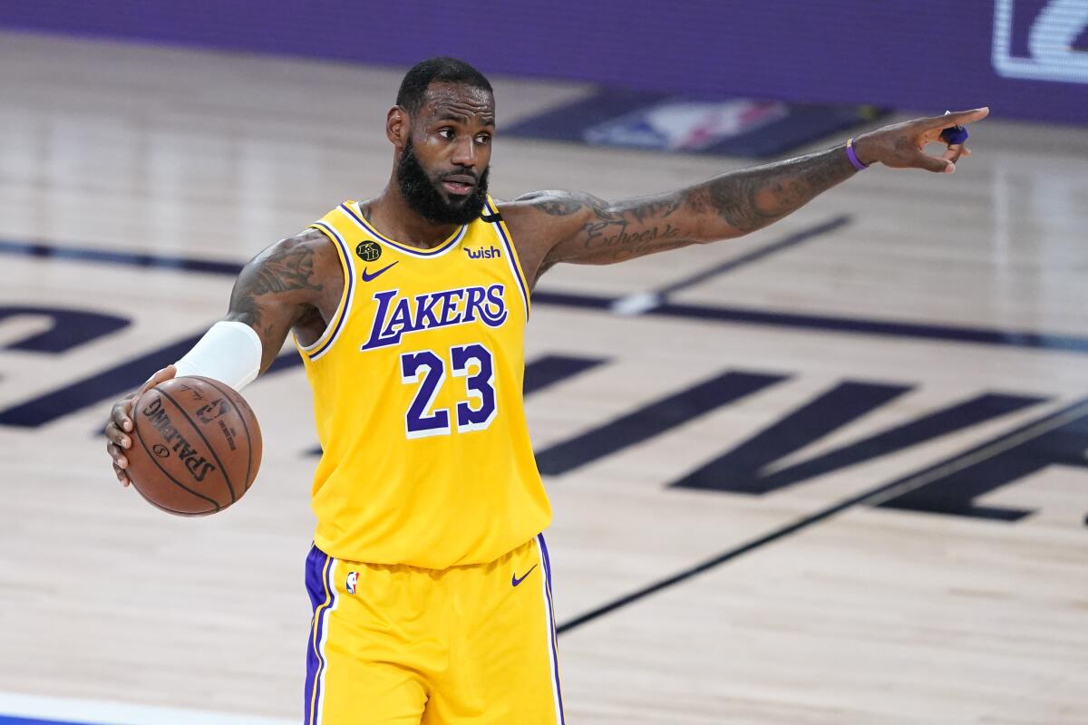 Lakers star LeBron James directs the play during a game.