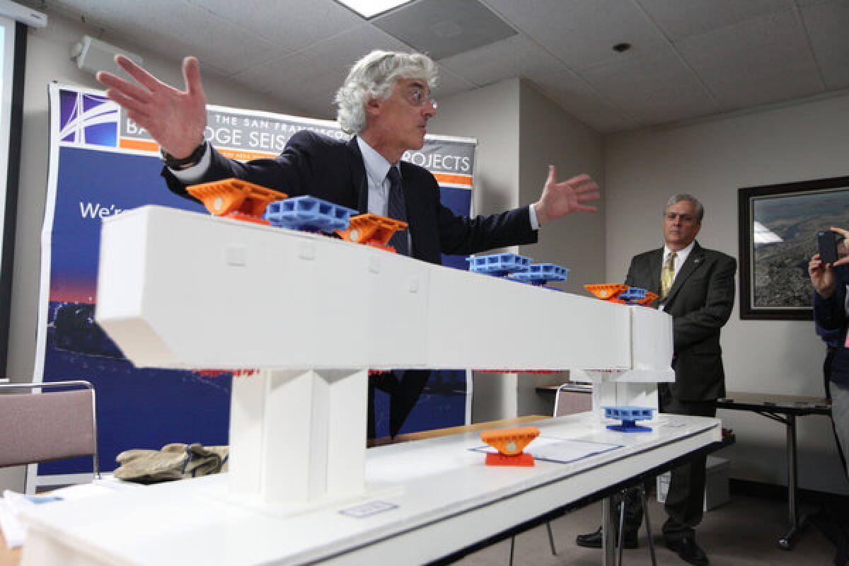 Bridge engineer Brian Maroney uses a model to explain the broken rod issue on the new span of the Bay Bridge.