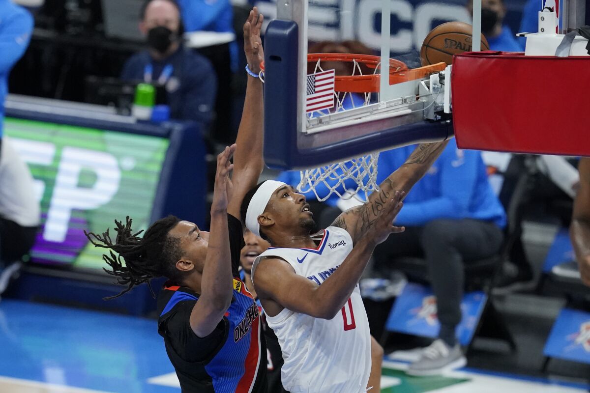 Clippers guard Jay Scrubb drives to the basket against Thunder center Moses Brown.