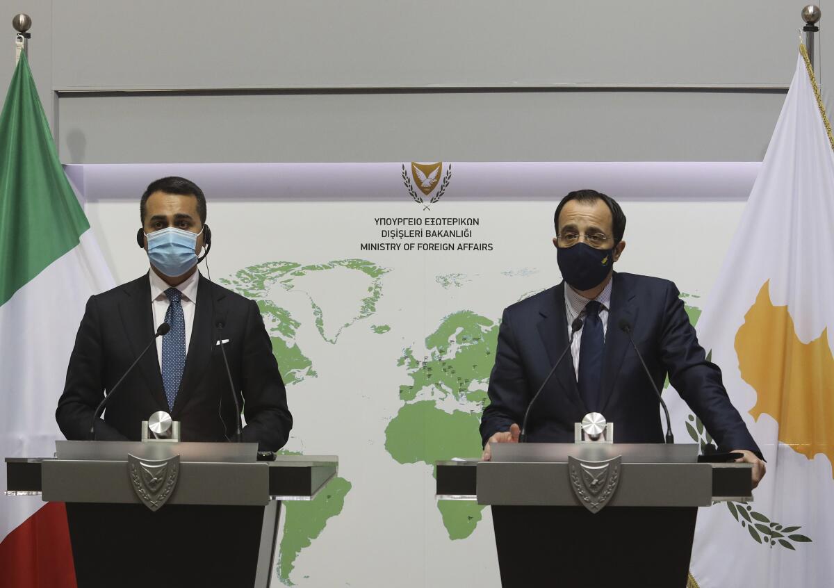 Cypriot Foreign Minister Nicos Christodoulides, right, and Italian Foreign Minister Luigi Di Maio talk to the media during a press conference after their meeting at the Foreign Ministry house in Nicosia, Cyprus, Tuesday March 9, 2021. Maio is in Cyprus for one-day visit. (Yiannis Kourtoglou/Pool via AP)