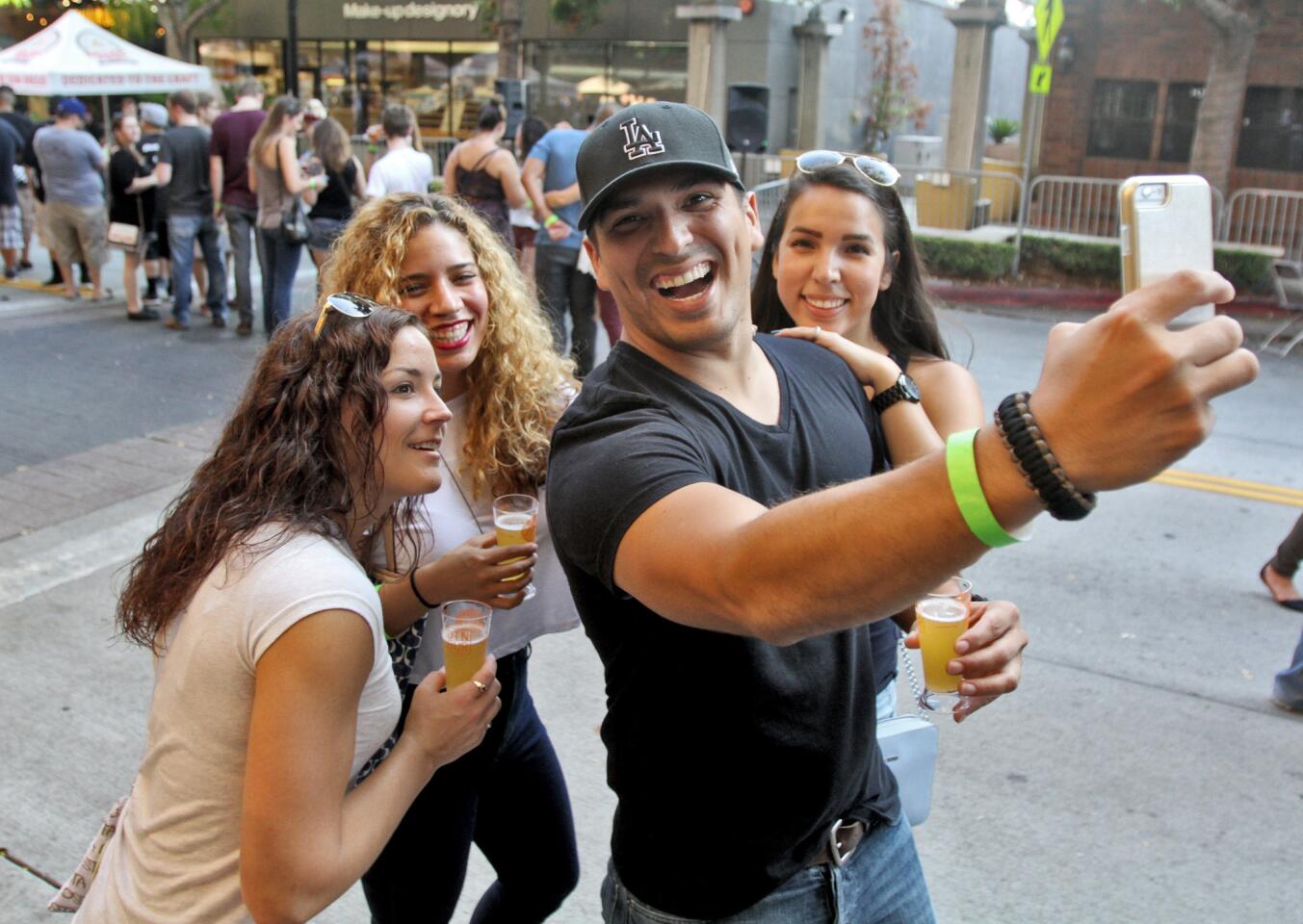 Johnathan Torrez of Santa Clarita, center, takes a selfie with friends and wife, from left, Alysa Valles, Amanda May and Raquel Torrez at the Burbank Beer Festival in downtown Burbank on Saturday, October 17, 2015.