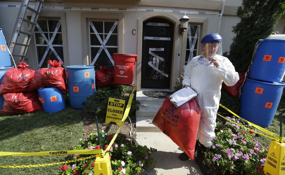 Homeowner James Faulk stands in front of an Ebola-themed Halloween display he made at his town home in the University Park section of Dallas on Oct. 23.