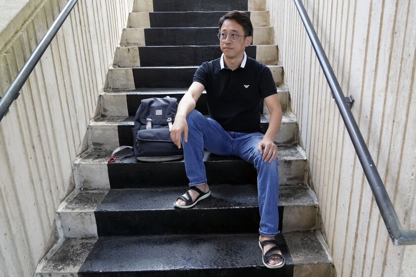 Miao Yu takes a break between class at the west campus of Valencia College, Monday, Jan. 30, 2023, in Orlando, Fla. Yu, a former bookseller, left China after his store was shut down for political reasons. (AP Photo/John Raoux)