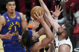 Denver Nuggets forward Aaron Gordon (50) drives to the basket as Miami Heat forward Kevin Love (42) during the second half of Game 3 of the NBA Finals basketball game, Wednesday, June 7, 2023, in Miami. (AP Photo/Rebecca Blackwell)