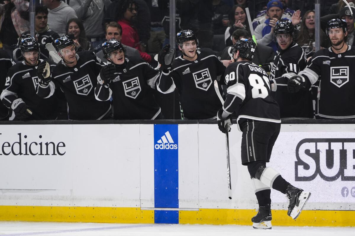 Kings center Pierre-Luc Dubois is congratulated by teammates on the bench after scoring against the Blue Jackets Tuesday
