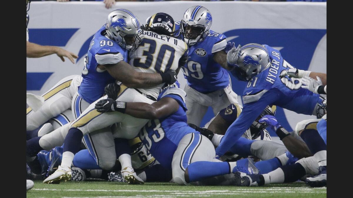 Rams running back Todd Gurley (30) is stopped by the Detroit Lions defense at the goal line on fourth down at the end of the first half.