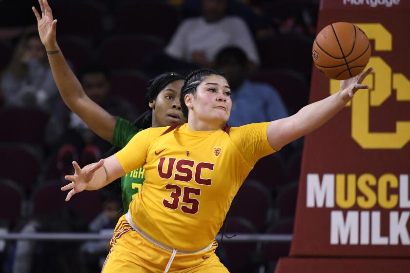 Southern California forward Alissa Pili, right, takes a pass as Oregon forward Ruthy Hebard defends during the second half of an NCAA college basketball game Sunday, Feb. 16, 2020, in Los Angeles. Oregon won 93-67. (AP Photo/Mark J. Terrill)
