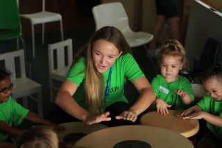 Camp Jam volunteer Emma Cochran works at a music therapy camp for youths with special needs.