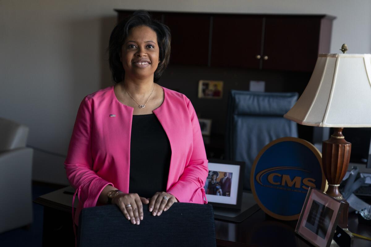 FILE - Chiquita Brooks-LaSure, the Administrator for the Centers of Medicare and Medicaid Services, poses for a photograph in her office, Wednesday, Feb. 9, 2022, in Washington. With Medicare's open enrollment underway, health experts are warning older adults about an uptick in misleading marketing tactics that might lead some to sign up for Medicare Advantage plans that don't cover their doctors or prescriptions and drive up their out-of-pocket costs. (AP Photo/Evan Vucci, File)