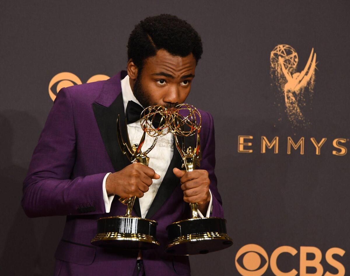 Donald Glover poses with his Emmys for lead actor in a comedy series and director of a comedy series, for "Atlanta."