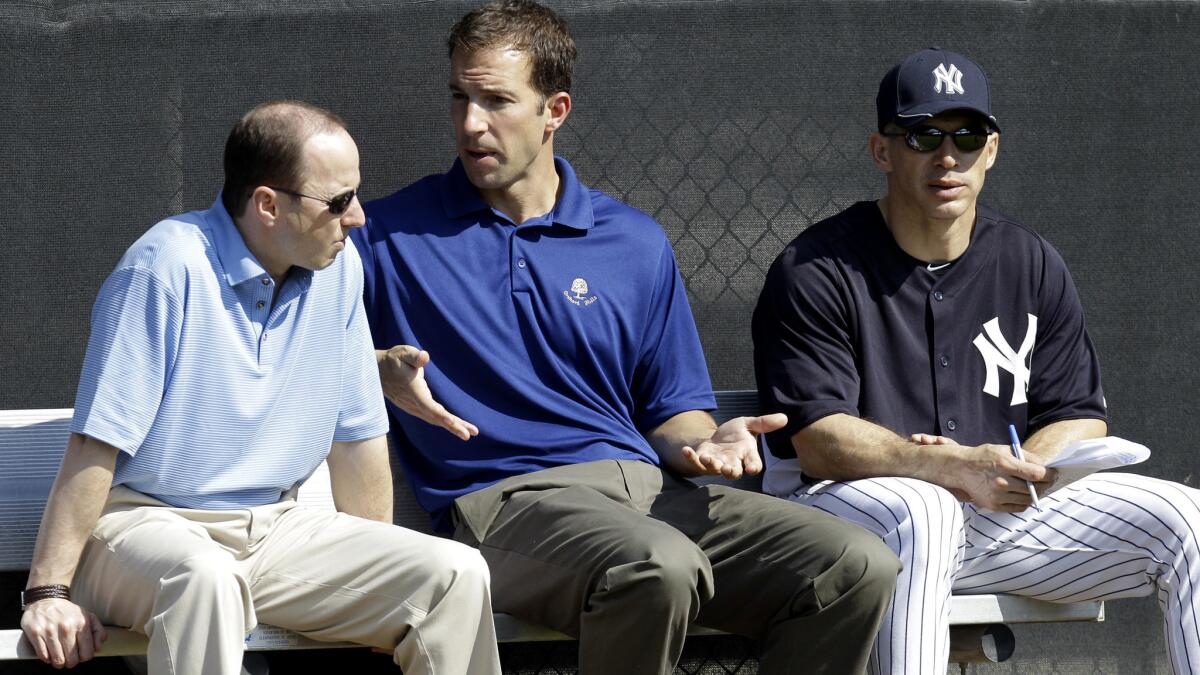 Billy Eppler, the Yankees' director of professional scouting, chats with GM Brian Cashman, left, and Manager Joe Girardi during spring training in Tampa, Fla.