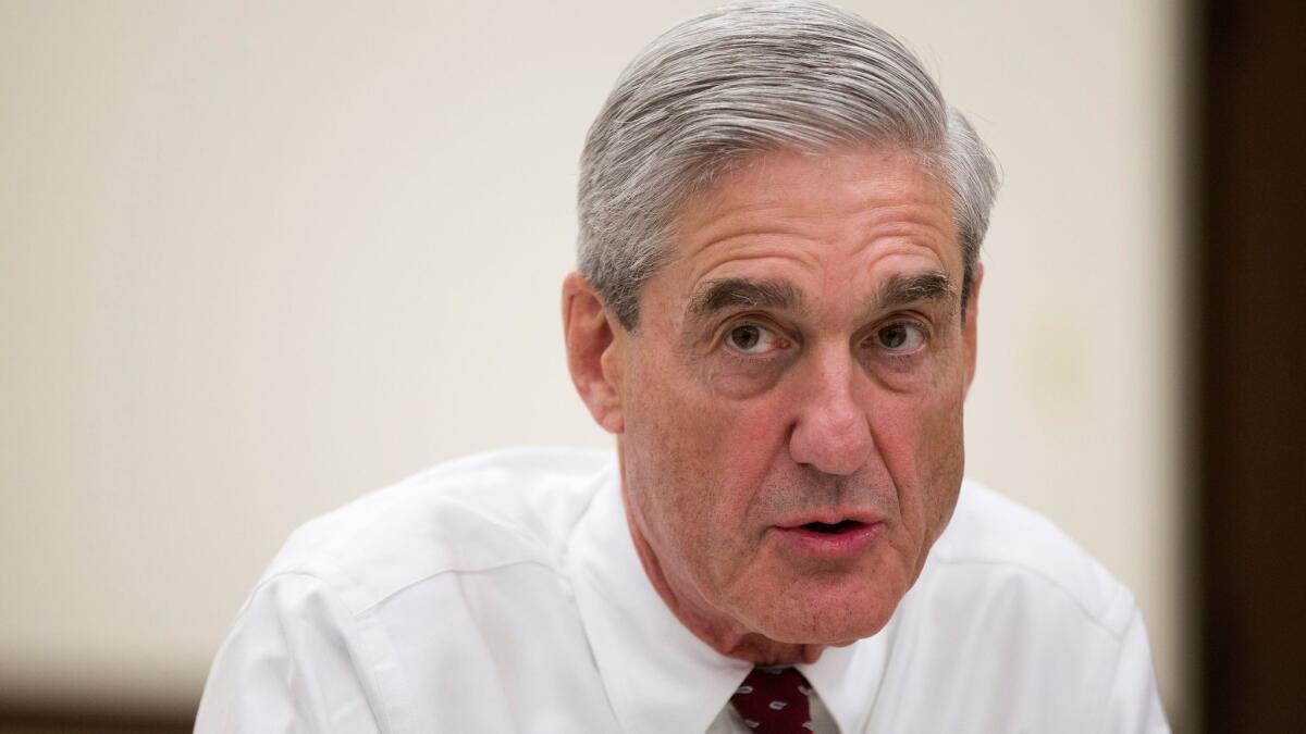 In this Aug. 21, 2013, file photo, then-FBI director Robert Mueller speaks during an interview at FBI headquarters in Washington.