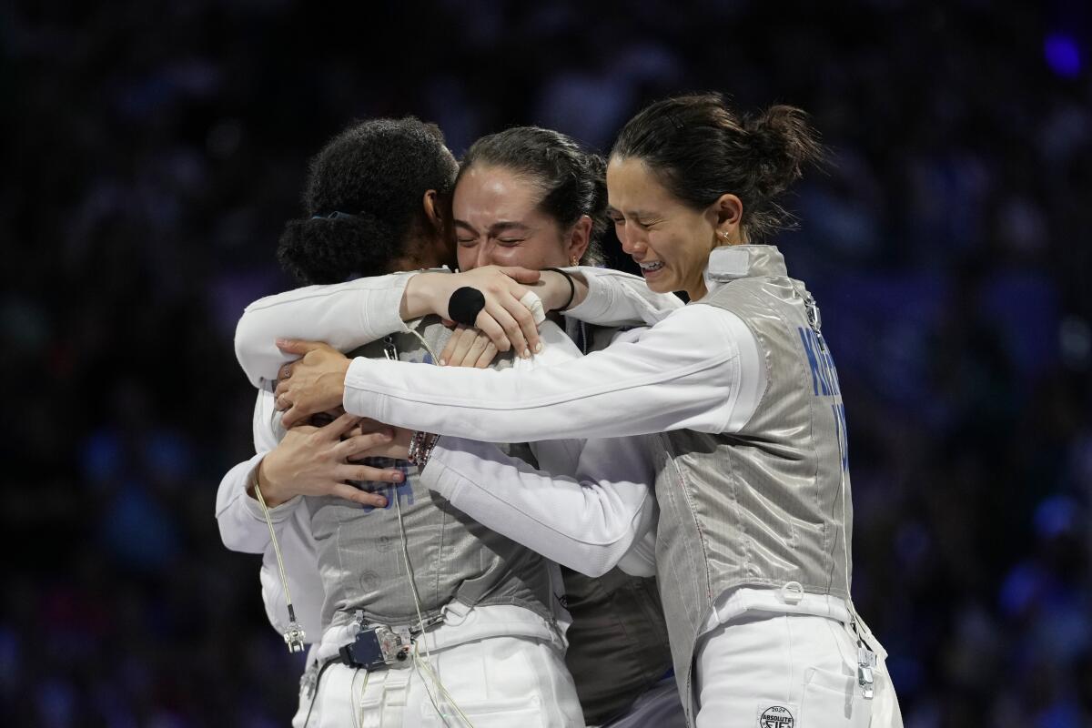 U.S. fencers Lee Kiefer, Lauren Scruggs, Jaqueline Dubrovich and Maia mei Weintraub celebrate after winning 