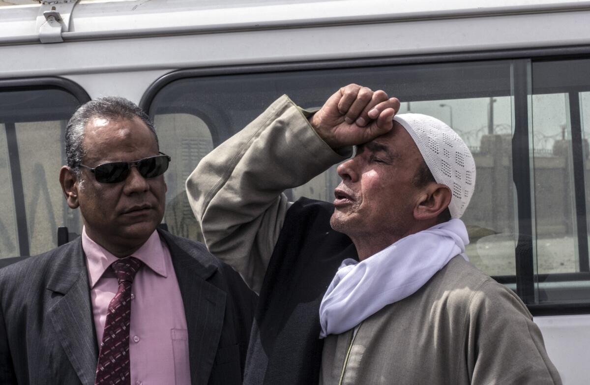 The father of one of the victims who died in a police van cries outside court in Cairo after the verdict was announced convicting four Egyptian police officers for the killings last summer of 37 protesters.