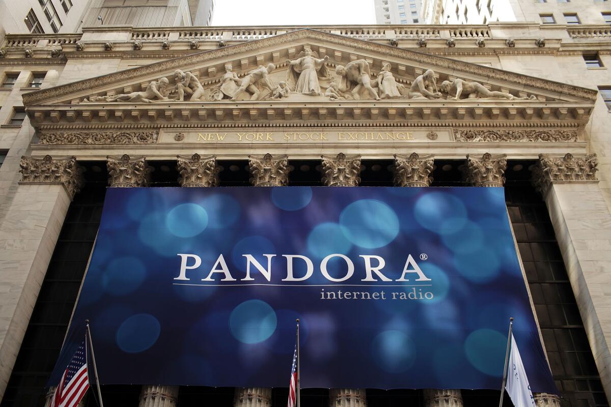 A banner for Pandora Media Inc. hangs in front of the New York Stock Exchange walk on its first day of trading as a public company on June 15, 2011, in New York City.