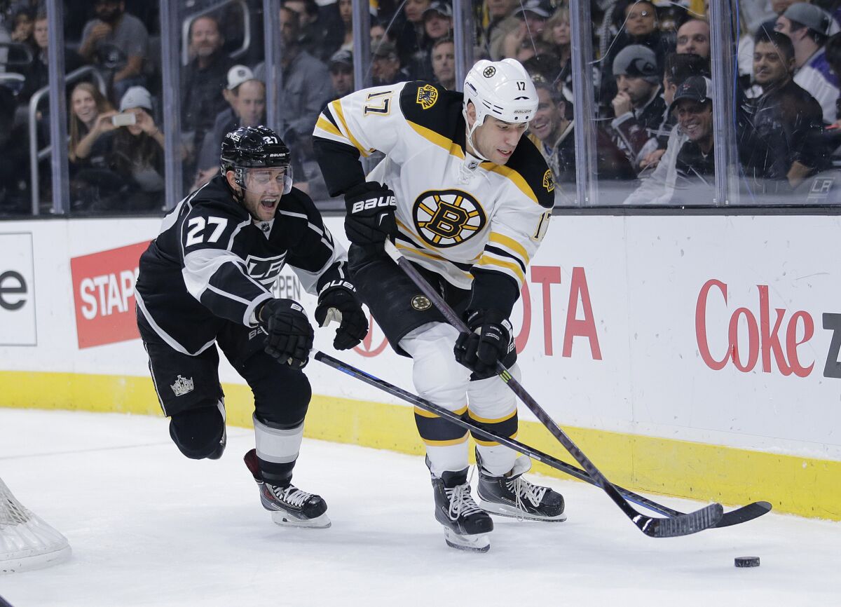 Alec Martinez chases Boston forward Milan Lucic during the first period of the Kings' 2-0 victory over the Bruins on Tuesday.