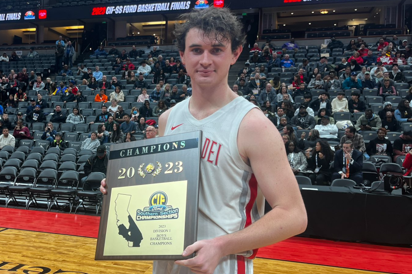 Mater Dei's Zack Davidson holds the boys' basketball Southern Section Division I championship plaque.