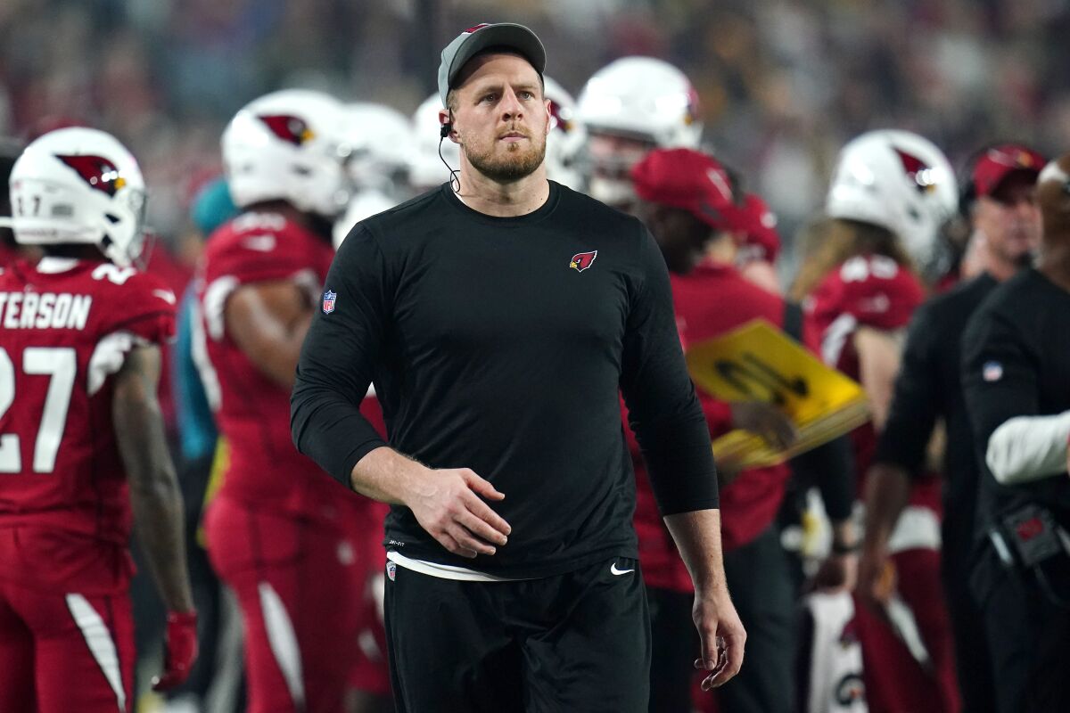 FILE - Arizona Cardinals defensive end J.J. Watt walks the sidelines during the first half of an NFL football game against the Indianapolis Colts, on Dec. 25, 2021, in Glendale, Ariz. The three-time NFL Defensive Player of the Year is trying to complete a miraculous comeback from a serious shoulder injury in an effort to help the Cardinals' defense when they travel to face the Los Angeles Rams on Monday night in the wild card round. (AP Photo/Ross D. Franklin, File)
