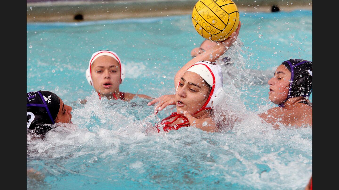 Glendale's Mondana Nassirpour, in a crowd, takes a shot to score against Hoover in a Pacific League girls' water polo match at Hoover High School on Thursday, January 12, 2017. Glendale won the match 14-9.