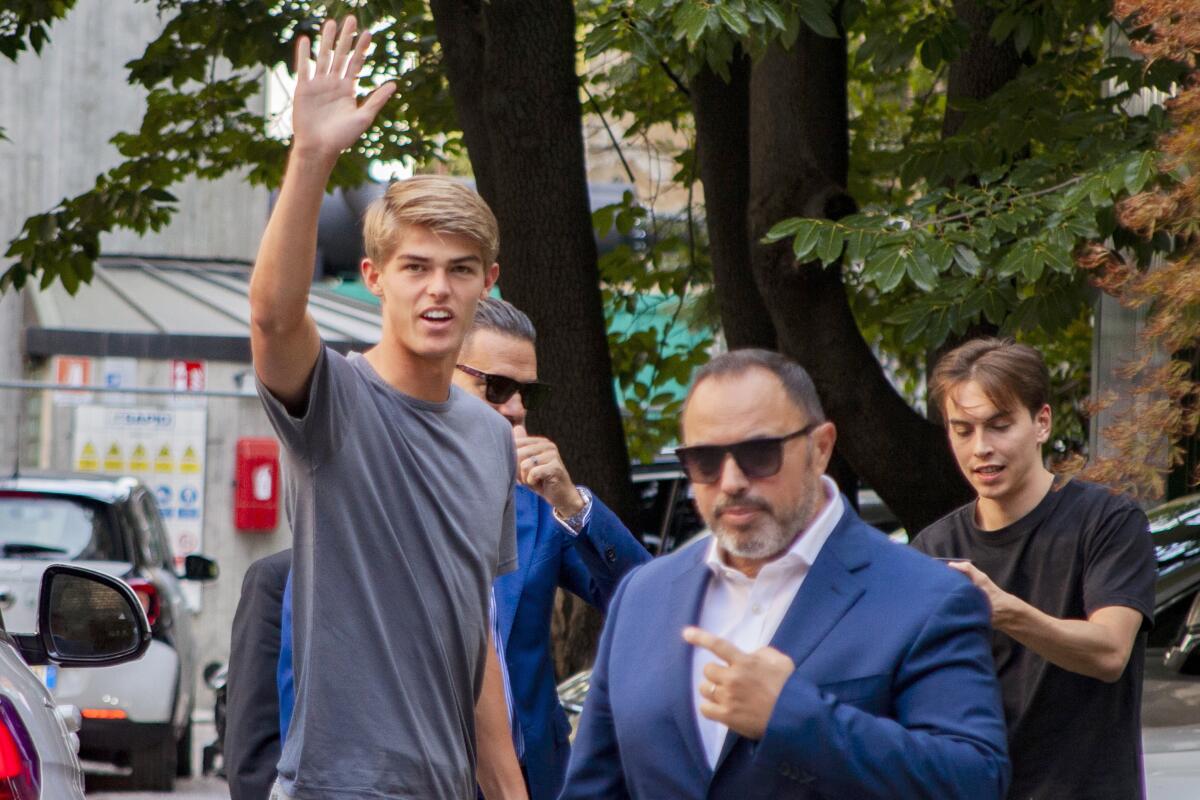 Charles De Ketelaere waves as he arrives for a medical check up in Milan, Italy, Tuesday, Aug. 2, 2022. AC Milan signed talented young playmaker Charles De Ketelaere from Club Brugge. (LaPresse via AP)