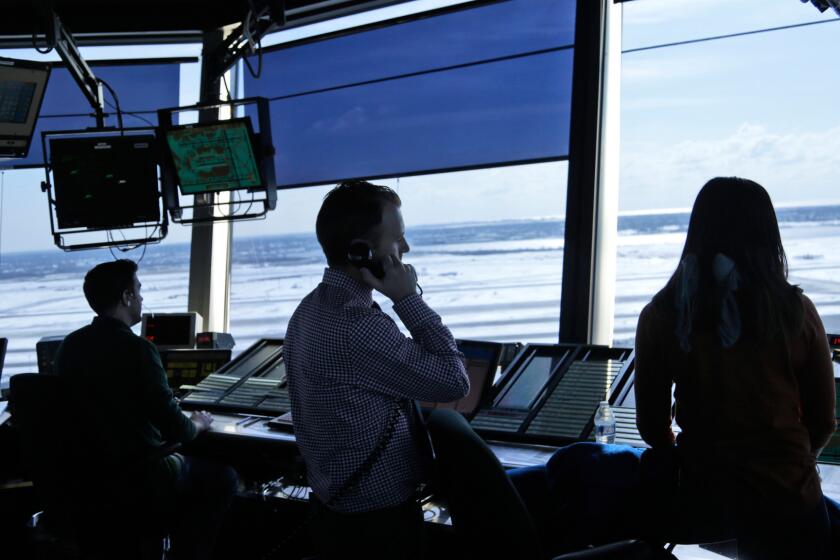 Air traffic controllers work in the tower at John F. Kennedy International Airport in New York, Thursday, March 16, 2017. President Donald Trump is calling for privatizing the nation's air traffic control operations in his budget proposal, a top priority of the airline industry. (AP Photo/Seth Wenig)