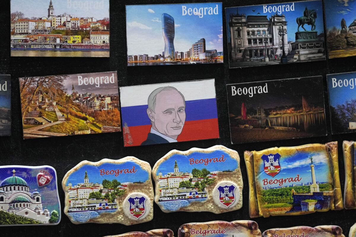 A vendor sells refrigerator magnets showing a picture of Russian President Vladimir Putin, on main pedestrian street in downtown Belgrade, Serbia, Monday, Jan. 16, 2023. Since the start of the war in Ukraine, about 200,000 Russians have left their homeland for Serbia, with many seeking a new life in a fraternal Slavic country free from Kremlin oppression. The Balkan country is a close ally of Moscow, with historic, religious and cultural ties, and Russia backs Serbia’s claim over its former province of Kosovo.(AP Photo/Darko Vojinovic)