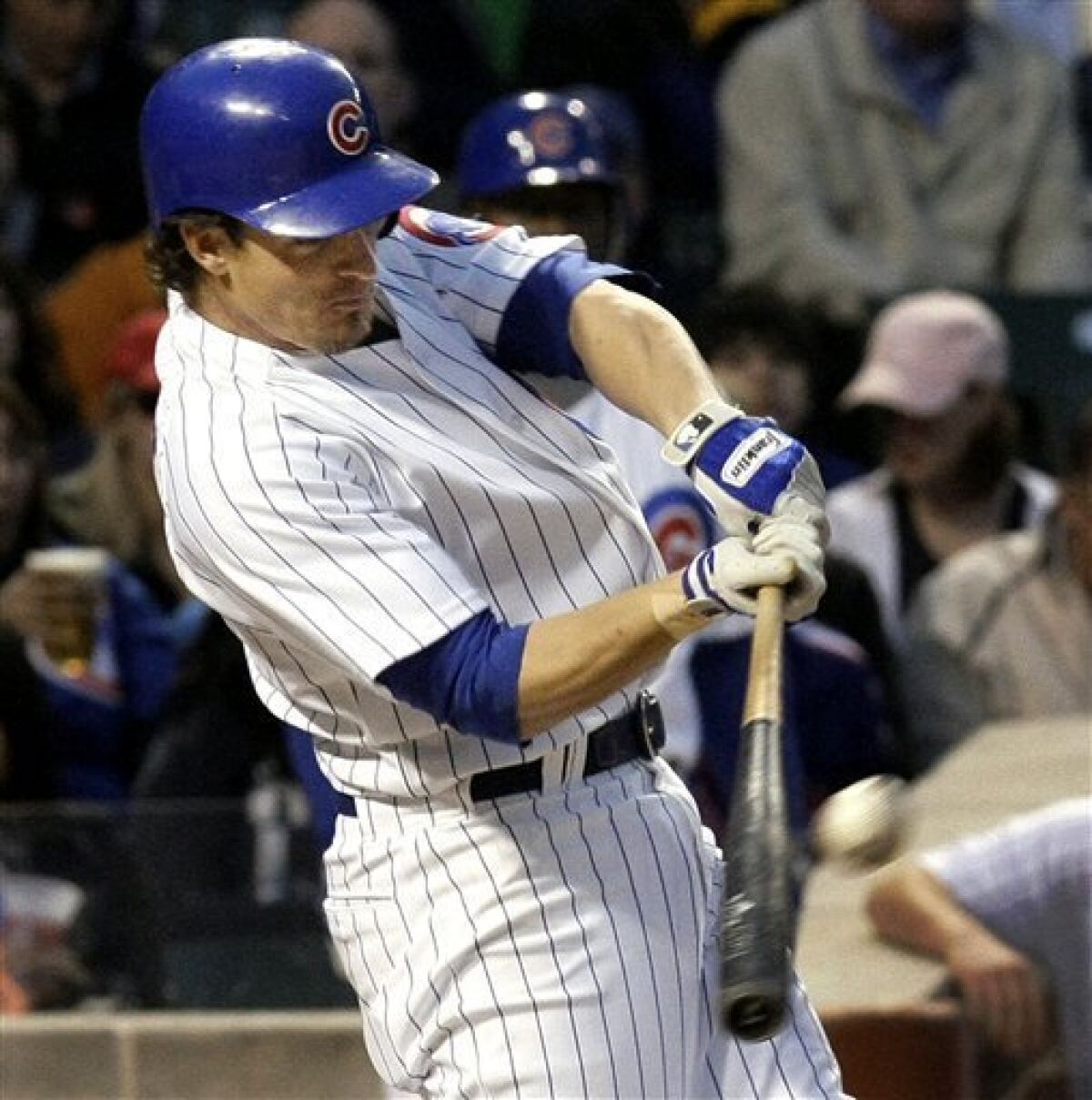 Chicago Cubs' Ryan Theriot connects for a two-run home run during the second inning of a baseball game against the San Francisco Giants at Wrigley Field in Chicago, Monday, May 4, 2009. Scoring on the play Cubs' Aaron Miles. (AP Photo/Charles Rex Arbogast)